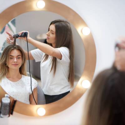 Blonde getting trendy hairstyle in beauty salon